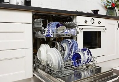 Porcelain plates and cups loaded in a dishwasher