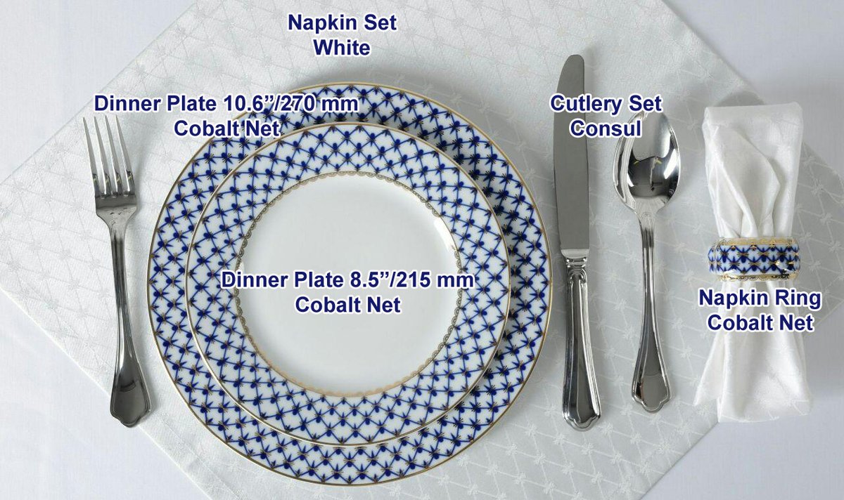 Place setting with Cobalt Net dinner plates, cutlery and a napkin ring